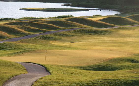 View of golf course with water